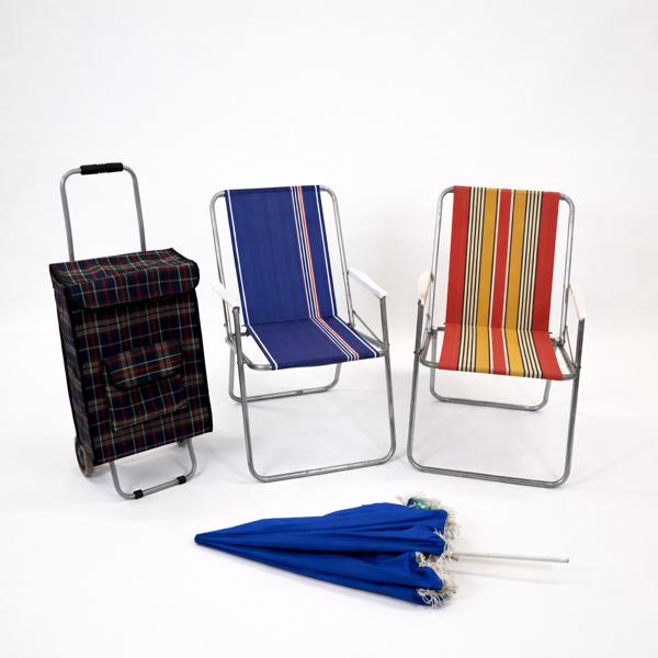 Campingstolar, ett par, shoppingvagn och ett parasoll. 