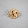 Brosch i 18k guld.